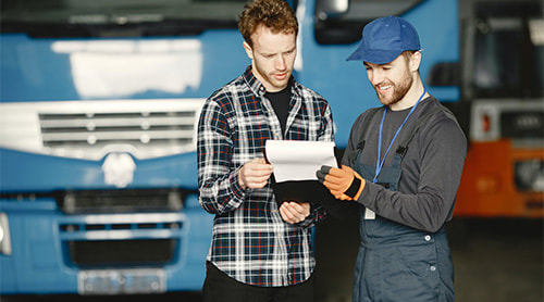Two men's talking behind truck photo